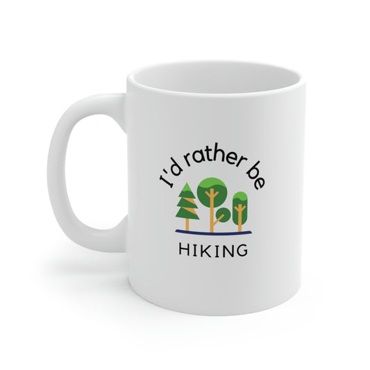 White ceramic coffee mug with minimalist drawing of trees and words "I'd rather be hiking" .