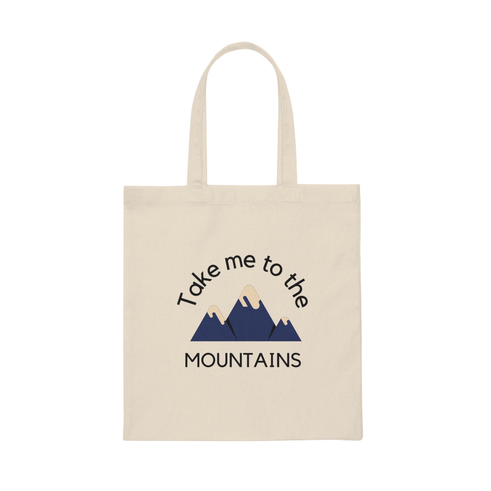 Canvas tote bag on white background with minimalist drawing of mountains and words "take me to the mountains". 