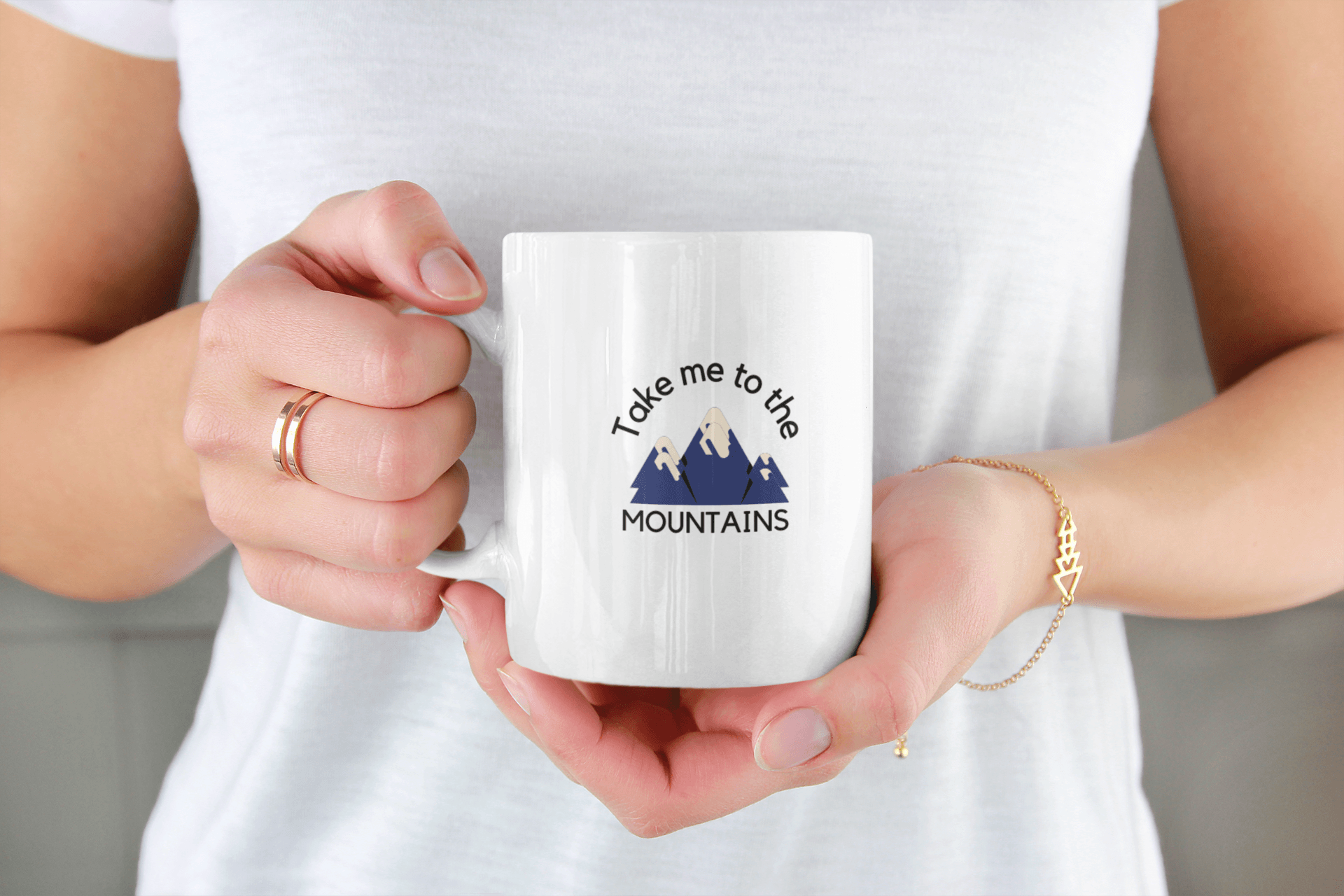 Woman holding a white ceramic coffee mug .
